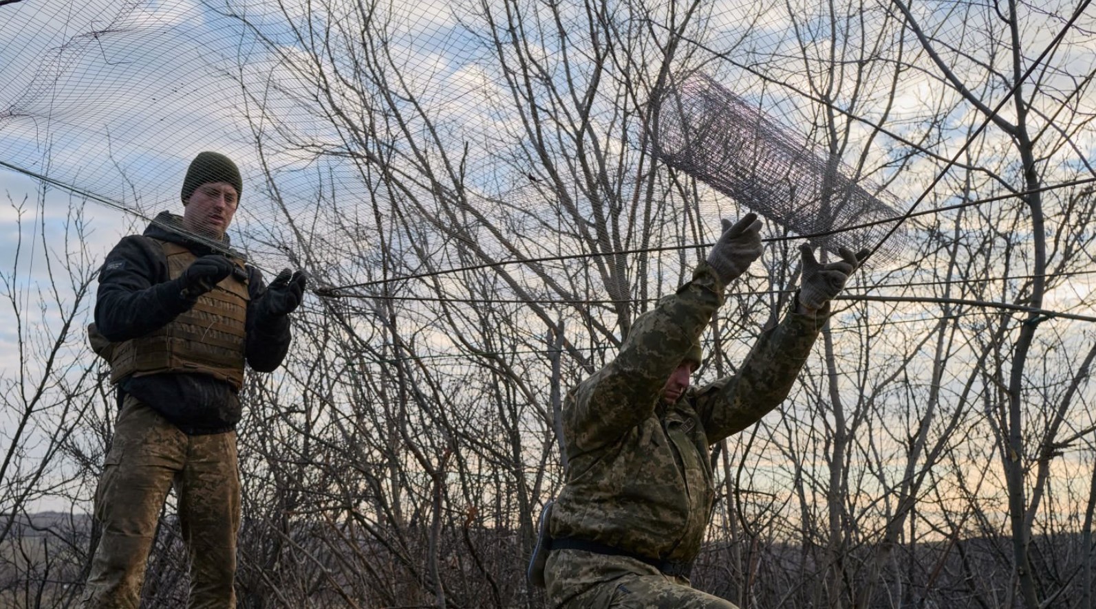 Артилеристи 55-ї бригади встановлюють захисну сітку над позицією гаубиці М777. Грудень 2022. Україна, Бахмутський напрямок. Фото: Кром Пьер